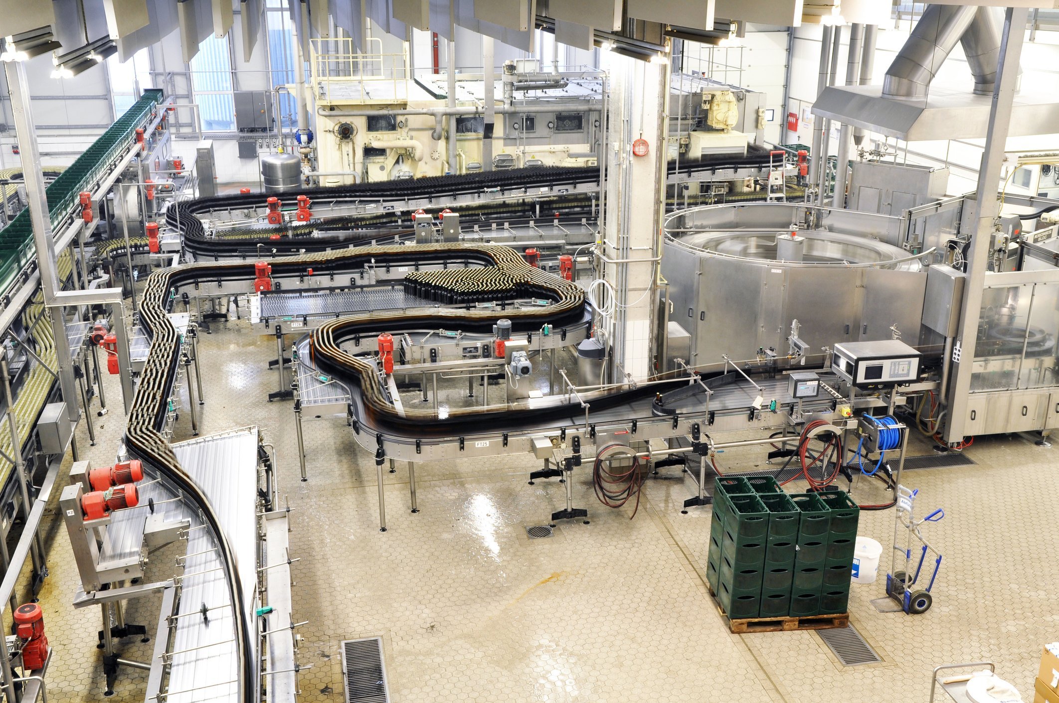 modern factory in the food industry - beer brewery - conveyor belt with beer bottles and machines for production